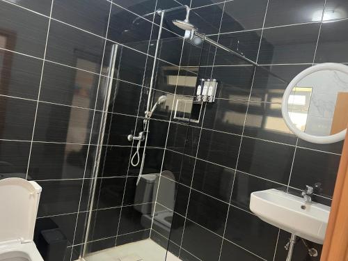 a bathroom with a shower and a toilet and a mirror at Salt & Sand T3 in Praia