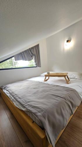 a bedroom with a bed with a table on it at Nord Hill in Poiana Negrii