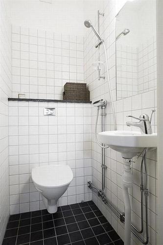 a white bathroom with a sink and a toilet at New Fortunate Guest House in Hong Kong