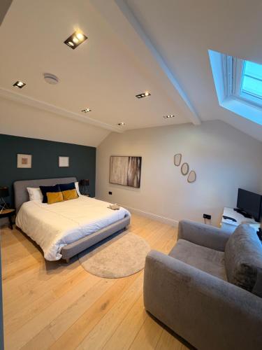 a bedroom with a bed and a couch at The stables at the Grange in York