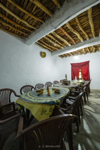 a row of tables and chairs with food on them at Gîte OUHDOU in Midelt