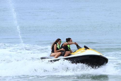 two people riding on a jet ski in the water at Kandaya Resort in Daanbantayan