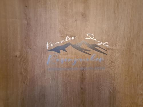 a sign on a wooden wall with writing on it at Apartment Kraxler Single by Interhome in Weißenstadt