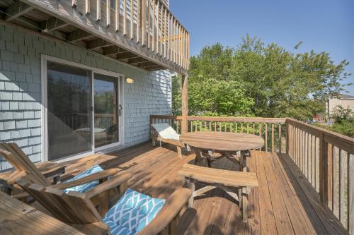 a wooden deck with a table and chairs on it at 3660 - Duckingham in Duck