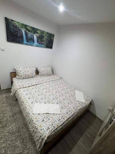 a small bedroom with a bed in the corner at Hidden Apartment in Miercurea-Ciuc