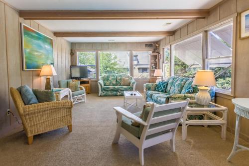 a living room with a couch and chairs and a tv at 4601 - Sandy Bluff in Southern Shores