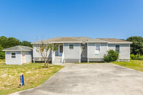 a house with a driveway in front of it at 4601 - Sandy Bluff in Southern Shores