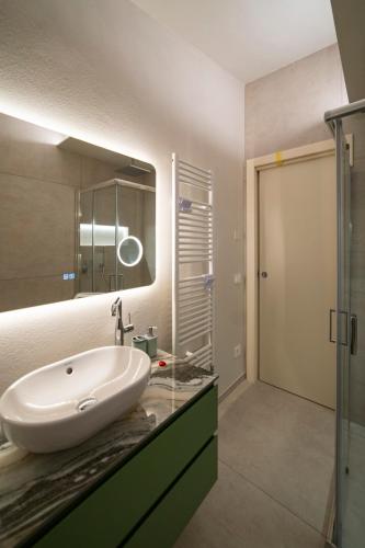 a bathroom with a sink and a mirror at CASA Virginia - DEEP BLUE in Predore
