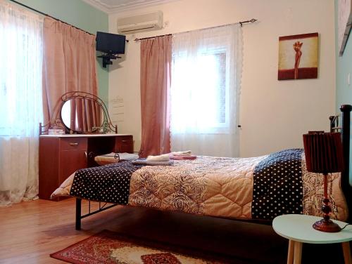 a bedroom with a bed and a window at Konstan'shouse in Mytilene