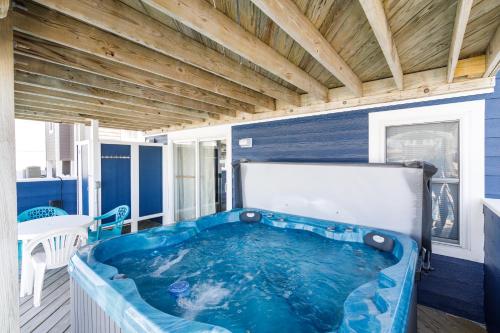 a jacuzzi tub on the back porch of a house at 4759 - Sun Daze in Kitty Hawk Beach