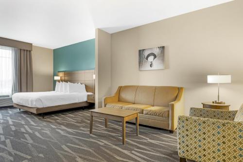 a hotel room with a bed and a couch at Best Western Plus Centralia Hotel & Suites in Centralia