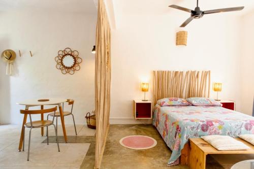 a bedroom with a bed and a table and a mirror at NEW MORINGA in Las Terrenas