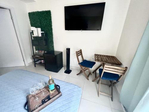 a living room with a tv and a table and chairs at Studio apartment- private entry! in Homestead