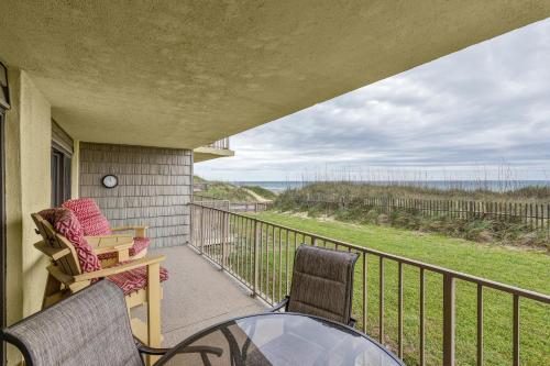 a balcony with a glass table and chairs on a porch at 5695 - Pelican's Perch in Nags Head