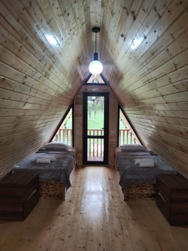 a large room with four beds in a wooden ceiling at vila pataraia in Martvili