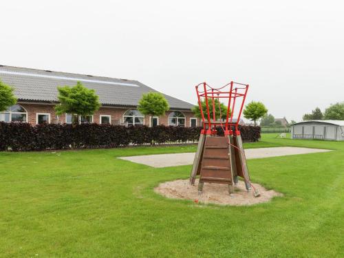 a playground with a slide in a yard at Apartment in Groede near the Beach in Groede