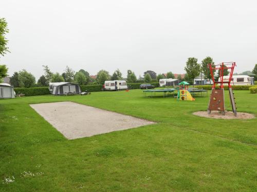 a park with a playground with tents and a play structure at Apartment in Groede near the Beach in Groede