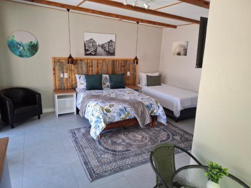 a bedroom with a bed and a desk and a chair at Fig Tree in Colesberg