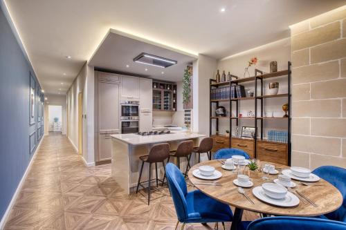 a kitchen and dining room with a table and chairs at NEW - Unique 3BR Apartment in Sought-After Area of Malta by SF Homes in Hal Ghaxiak