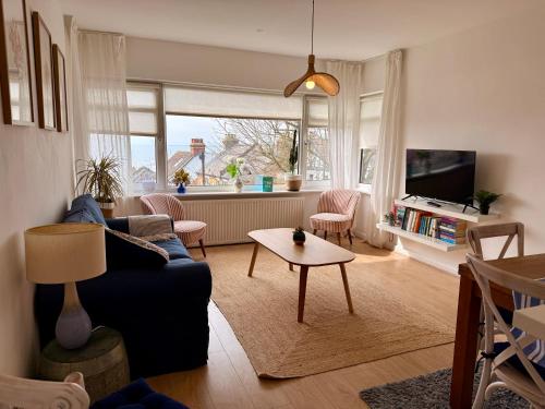 a living room with a couch and a table at No9 Estuary Views in Southend-on-Sea