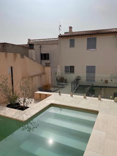 a large swimming pool in front of a building at s'Herència in Porreres