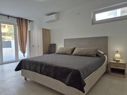 a bedroom with a large bed and a window at Apartment Natalija A2 ground floor in Krk