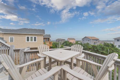 a table and chairs on the deck of a house at 7651 - Sandrose in Avon
