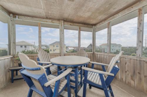 a porch with a table and four chairs at 7651 - Sandrose in Avon