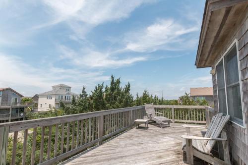 a deck with a bench and a chair on it at 7838 - Wilder View in Frisco