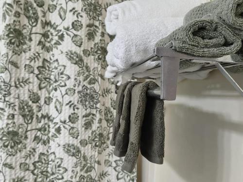 a pile of towels on a rack next to a bed at Condo-Hotel on Collins ave in Sunny Isles Beach