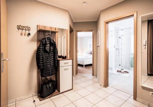 a hallway with a coat hanging on a wall at Ferienwohnung Strand-Domizil Zingst in Niederdorla