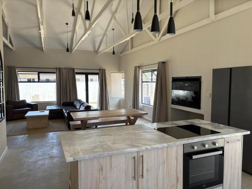 una cucina con un tavolo e un soggiorno di House Stillmar a Walvis Bay