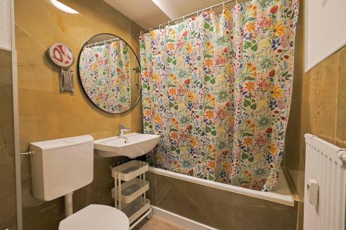 a bathroom with a shower curtain and a sink at KasselRooms Comfort Studio in Kassel