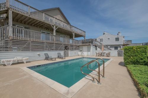 a swimming pool in front of a house at 2931 - Lighthouse in Duck