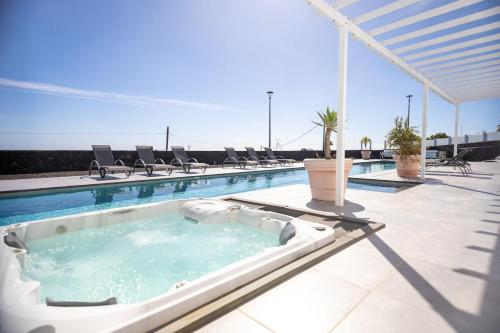 a swimming pool with a hot tub on a building at Casa Conil Private 25m Heated Pool with Hydraulic Mobility Lift in Conil