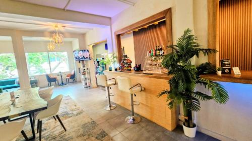 a restaurant with a bar with a table and chairs at Somos Hotel San Juan in San Juan