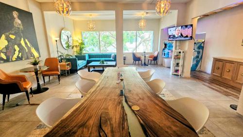 a living room with a large wooden table and chairs at Somos Hotel San Juan in San Juan