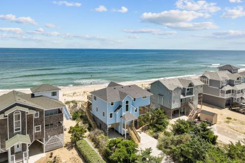 an aerial view of a row of houses on the beach at 7675 - Sweet Caroline in Avon