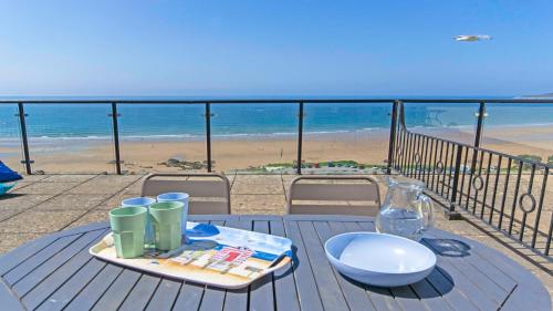 a table with a tray of food on top of a beach at Apt 16 Seaviews Slps 5 Indoor Heated Pool in Croyde