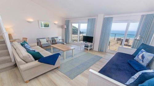a living room with a view of the ocean at Apt 16 Seaviews Slps 5 Indoor Heated Pool in Croyde