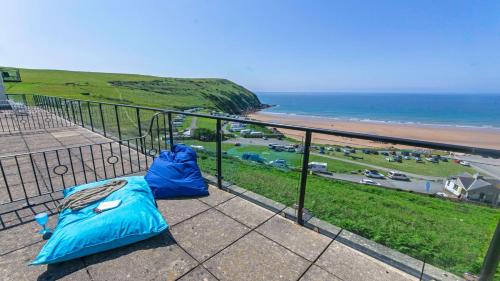 a balcony with a view of the ocean and a beach at Apt 16 Seaviews Slps 5 Indoor Heated Pool in Croyde
