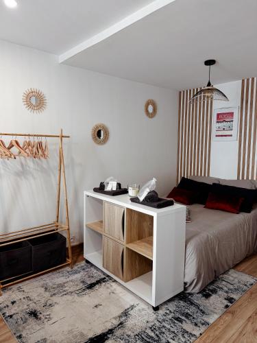 a bedroom with a bed and a white cabinet at Le Repaire blterrois in Béziers