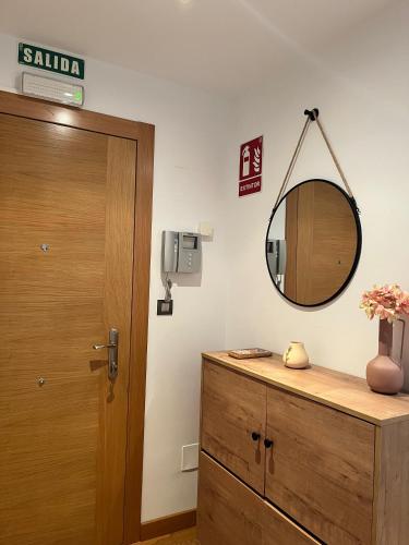 a bathroom with a mirror and a wooden door at El rincon del Cares in Panes