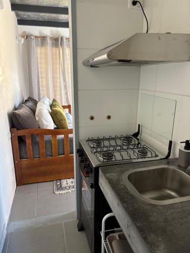 a kitchen with a stove and a sink at Apart Las Tunas Carmelo in Carmelo