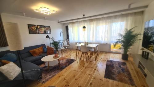 a living room with a couch and a table at TARNO Lake Apartment in Tarnobrzeg