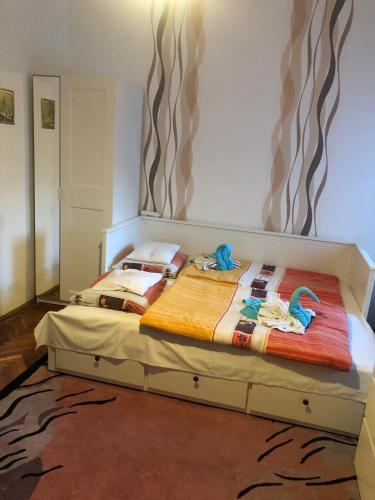 a bedroom with a bed with towels on it at Dombi Porta in Erdőbénye