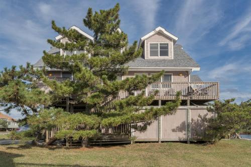 a house with a pine tree in front of it at 7657 - Dragon's Lair in Avon
