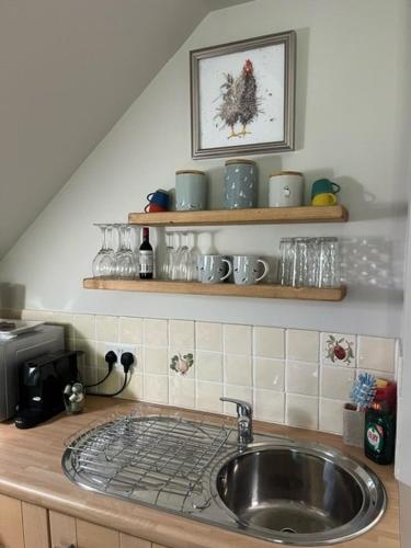 a kitchen counter with a sink in a kitchen at The Bird Loft Studio in Horsted Keynes