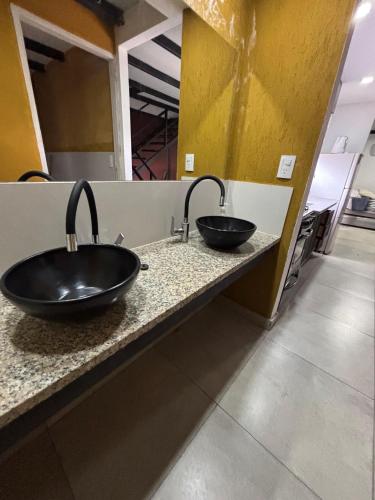 a bathroom with two sinks on a counter at CABAÑAS EL CERRO in Ciudad Lujan de Cuyo