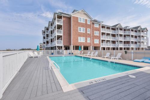 a swimming pool in front of a apartment building at C103A - Sweet Sound Memories in Nags Head